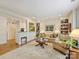 Cozy living room featuring built-in bookshelves, a large area rug, and a view into the kitchen at 916 Cherokee Rd, Charlotte, NC 28207
