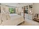 Bright main bedroom with large windows, built-in shelving, and a four-poster bed at 916 Cherokee Rd, Charlotte, NC 28207