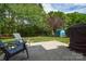 Spacious backyard with mature trees, storage shed, patio area, and great outdoor seating at 9713 Autumn Applause Dr, Charlotte, NC 28277