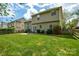 Large backyard with green grass, a patio area, and surrounding trees, perfect for outdoor gatherings and relaxation at 9713 Autumn Applause Dr, Charlotte, NC 28277