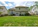 Expansive backyard with lush green grass, a patio, and well-maintained landscaping, ideal for outdoor activities at 9713 Autumn Applause Dr, Charlotte, NC 28277