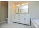 Bathroom featuring a double sink vanity, marble floors, and ample storage, offering a luxurious and functional space at 9713 Autumn Applause Dr, Charlotte, NC 28277