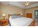 Bedroom showcasing neutral walls, a tray ceiling, and wood furniture, creating a warm and inviting atmosphere at 9713 Autumn Applause Dr, Charlotte, NC 28277
