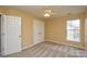Bedroom with neutral paint, standard closet, window, and ceiling fan at 9713 Autumn Applause Dr, Charlotte, NC 28277
