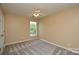 Bedroom with neutral paint, window, ceiling fan, and carpeted floors at 9713 Autumn Applause Dr, Charlotte, NC 28277