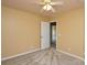Bedroom with neutral paint, window, ceiling fan, and a view into the hallway at 9713 Autumn Applause Dr, Charlotte, NC 28277