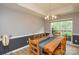 Charming dining room with wooden table, stylish chandelier, and abundant natural light at 9713 Autumn Applause Dr, Charlotte, NC 28277