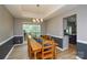 Bright dining room with wooden table, chandelier, and large window at 9713 Autumn Applause Dr, Charlotte, NC 28277