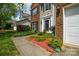 Attractive two-story home with brick, manicured landscaping, and sidewalk, offering classic curb appeal at 9713 Autumn Applause Dr, Charlotte, NC 28277