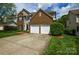 Charming two-story home features a brick facade, attached two-car garage, and a well-manicured front lawn at 9713 Autumn Applause Dr, Charlotte, NC 28277