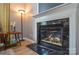 Elegant fireplace with black marble surround and white mantel, complemented by cozy lighting at 9713 Autumn Applause Dr, Charlotte, NC 28277