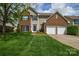 Charming two-story brick home with a well-manicured lawn and attached two-car garage at 9713 Autumn Applause Dr, Charlotte, NC 28277