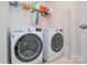 Well-lit laundry room featuring a modern washer and dryer set, complemented by ample storage and organization solutions at 9713 Autumn Applause Dr, Charlotte, NC 28277