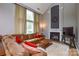 Elegant living room with a cozy fireplace, plush seating, and large windows providing ample natural light at 9713 Autumn Applause Dr, Charlotte, NC 28277