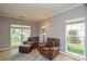 Comfortable living room featuring plush leather chairs and ample natural light at 9713 Autumn Applause Dr, Charlotte, NC 28277