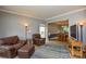 Inviting living room with leather seating, rug, and views into the dining area at 9713 Autumn Applause Dr, Charlotte, NC 28277