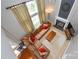 Open living room view with comfortable seating, a fireplace, and natural light from large windows at 9713 Autumn Applause Dr, Charlotte, NC 28277