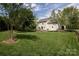 Large backyard with a meticulously kept lawn and mature trees, ideal for outdoor activities at 1002 Banaba Dr, Indian Trail, NC 28079