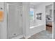 Clean bathroom with a glass-enclosed shower and soaking tub at 1002 Banaba Dr, Indian Trail, NC 28079