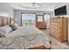 Bright bedroom with a tray ceiling, large windows, and wooden furniture at 1002 Banaba Dr, Indian Trail, NC 28079