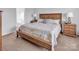 Cozy bedroom featuring a wooden bed frame, patterned bedding, and matching bedside tables at 1002 Banaba Dr, Indian Trail, NC 28079