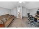 Multi-purpose bonus room with a comfortable futon, office setup, and a doorway to another level at 1002 Banaba Dr, Indian Trail, NC 28079