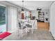 Cozy dining area with white table and chairs, sliding glass door, and connection to the office at 1002 Banaba Dr, Indian Trail, NC 28079