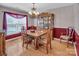 Traditional dining room features a wooden table and hutch illuminated by a chandelier and natural light at 1002 Banaba Dr, Indian Trail, NC 28079