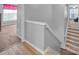 Bright staircase leading to a lovely room featuring hardwood steps and white banisters at 1002 Banaba Dr, Indian Trail, NC 28079