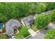 An aerial view of the property features a well-manicured lawn, mature trees, and surrounding neighborhood at 1009 Anduin Falls Dr, Charlotte, NC 28269