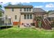 The backyard offers a patio seating area with Adirondack chairs, complemented by a trampoline on the lawn at 1009 Anduin Falls Dr, Charlotte, NC 28269