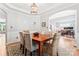Well-appointed dining room with wood table, stylish chairs, chandelier, and seamless transition to the living area at 1009 Anduin Falls Dr, Charlotte, NC 28269