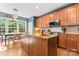 Charming kitchen with wood cabinets, granite countertops, and a center island; eat-in area adjacent at 1009 Anduin Falls Dr, Charlotte, NC 28269