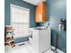 Functional laundry room with modern appliances, storage, and window at 1009 Anduin Falls Dr, Charlotte, NC 28269