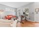 Cozy living room featuring hardwood floors, bright windows, and comfortable seating, ideal for relaxation at 1009 Anduin Falls Dr, Charlotte, NC 28269