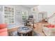 Bright living room with hardwood floors, a large window, and a view of the dining area, creating an open and airy feel at 1009 Anduin Falls Dr, Charlotte, NC 28269