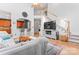 Bright living room featuring bar seating, hardwood floors, fireplace, and staircase at 1009 Anduin Falls Dr, Charlotte, NC 28269