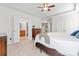 Relaxing main bedroom features neutral walls, a ceiling fan, and access to an ensuite bathroom and closet at 1009 Anduin Falls Dr, Charlotte, NC 28269