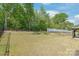A sprawling backyard has mature trees and a gazebo for outdoor enjoyment at 1020 Clementine Rd, Monroe, NC 28110