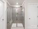 Contemporary bathroom featuring a walk-in shower with glass doors and tiled walls at 1020 Clementine Rd, Monroe, NC 28110