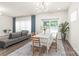Open concept living area with dining table, couch and sliding glass doors at 1020 Clementine Rd, Monroe, NC 28110