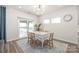 Cozy dining area with a table for six, modern chandelier, and lots of natural light at 1020 Clementine Rd, Monroe, NC 28110