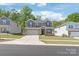 Charming two-story home featuring a brick and siding facade, complemented by a well-kept lawn and a two-car garage at 1020 Clementine Rd, Monroe, NC 28110
