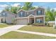 Charming two-story home with brick and siding, a well-maintained lawn, and an attached two-car garage at 1020 Clementine Rd, Monroe, NC 28110