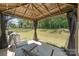 A gazebo with seating overlooks the lawn and wooded area at 1020 Clementine Rd, Monroe, NC 28110