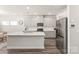 Bright kitchen features gray cabinets, stainless appliances and a quartz island at 1020 Clementine Rd, Monroe, NC 28110