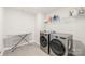 A modern laundry room with front-load washer and dryer plus overhead shelf at 1020 Clementine Rd, Monroe, NC 28110