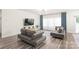 Open-concept living room features two couches, large windows with flowing sheer and blue curtains at 1020 Clementine Rd, Monroe, NC 28110