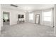 Bright living room with neutral tones, a modern light fixture, and a view into another room at 1020 Clementine Rd, Monroe, NC 28110