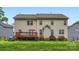 Back exterior view of the home with a wooden deck and well-maintained lawn at 10836 Maryanna Ct, Charlotte, NC 28213